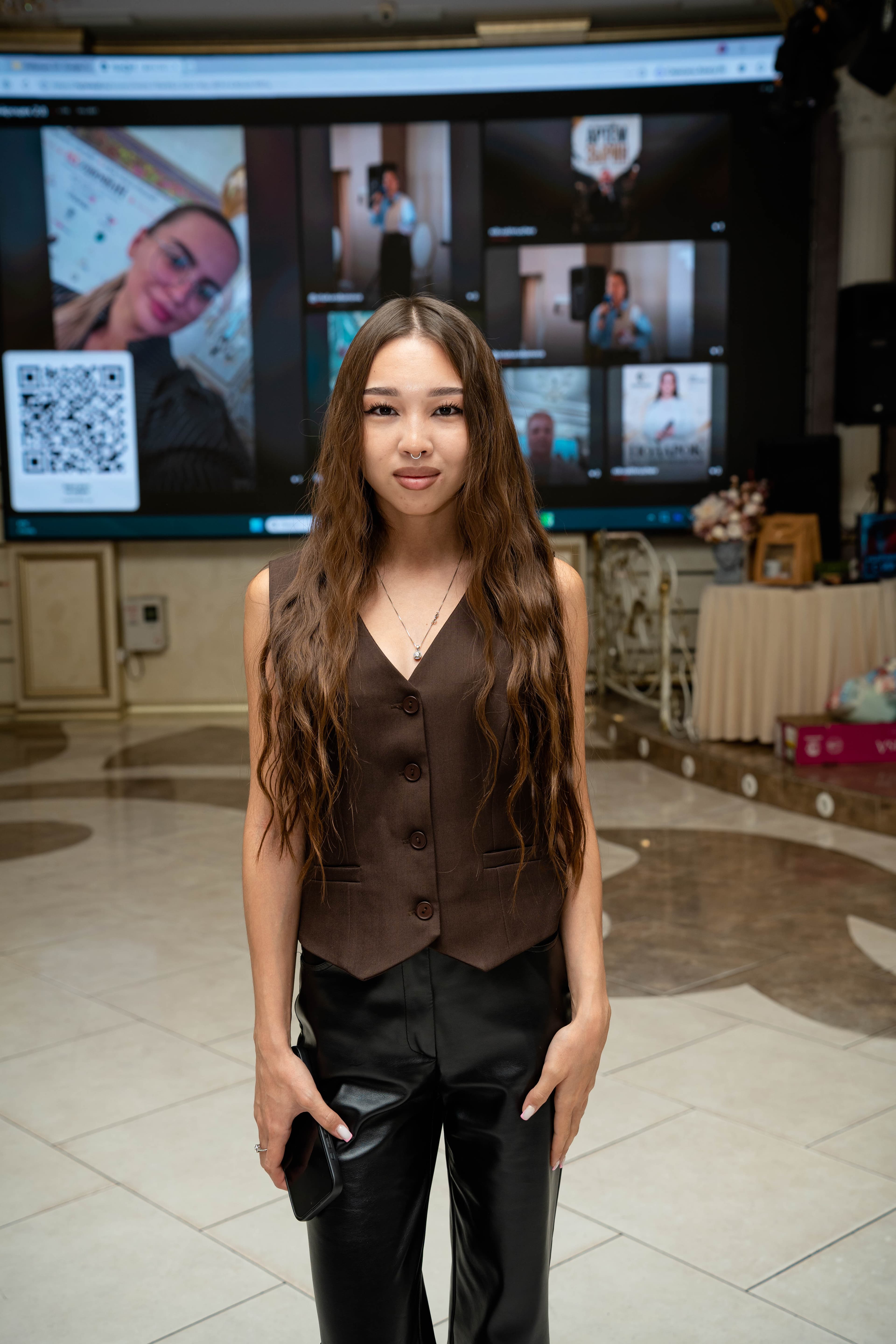 Guest beside the event photo screen